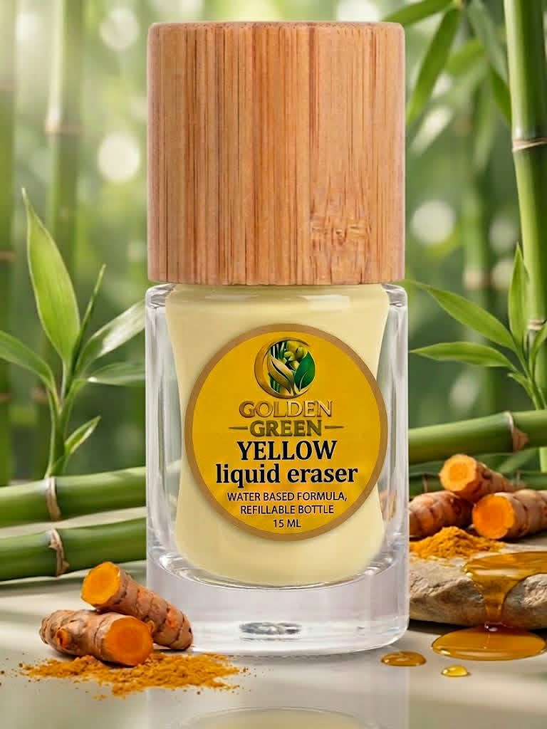 Golden Green Yellow Liquid Eraser bottle with bamboo cap, set against bamboo stalks and turmeric